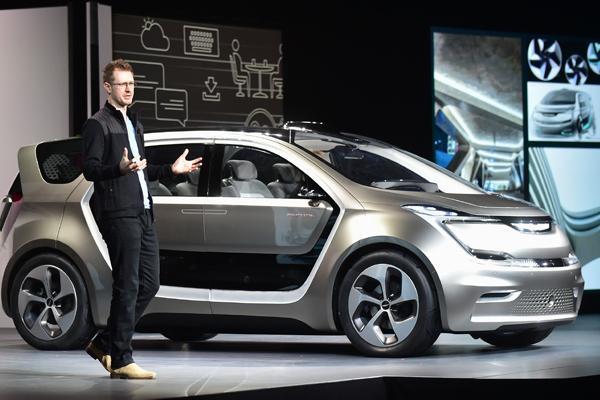 Exterior designer Matt Dunford speaks beside the unveiled Fiat Chrysler Portal Concept car during the Fiat Chrysler press conference at the 2017 Consumer Electronics Show (CES2017) in Las Vegas, Nevada, on January 3, 2017. Frederic J. BROWN / AFP